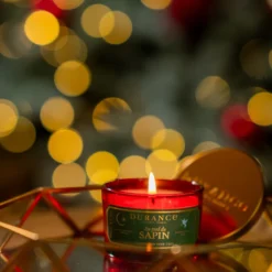 Petite bougie parfumée au pied du sapin