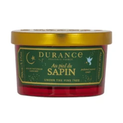 Petite bougie parfumée au pied du sapin