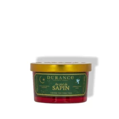 Petite bougie parfumée au pied du sapin